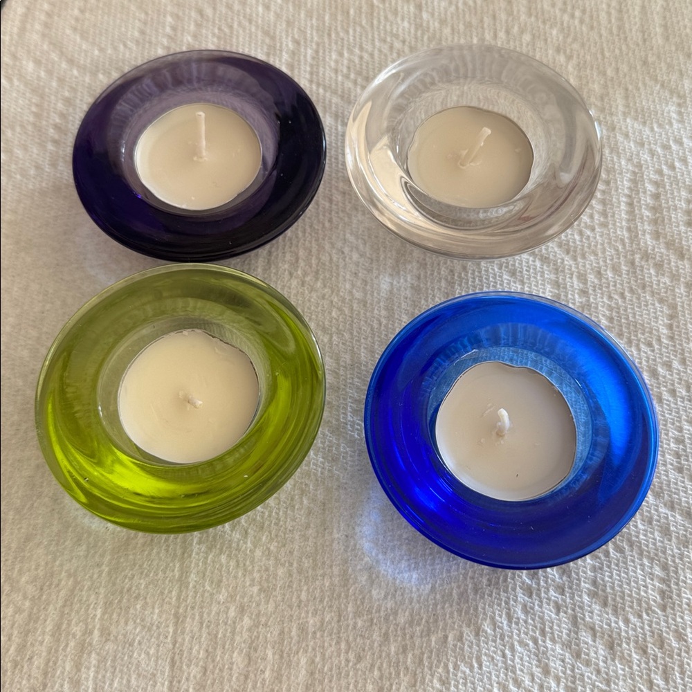 Crate & Barrel set of 4 multicolored tealights cobalt, clear, purple, lime.
